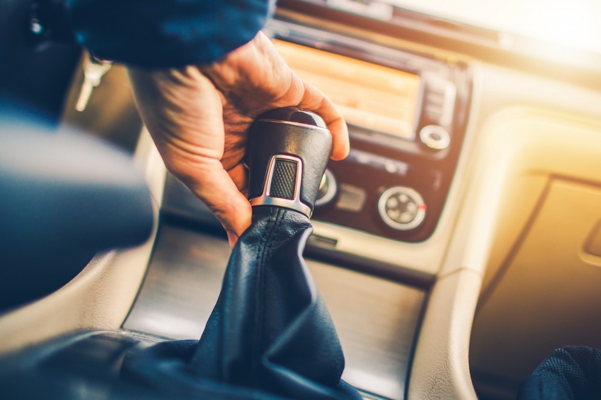 hand on the shifter of a car