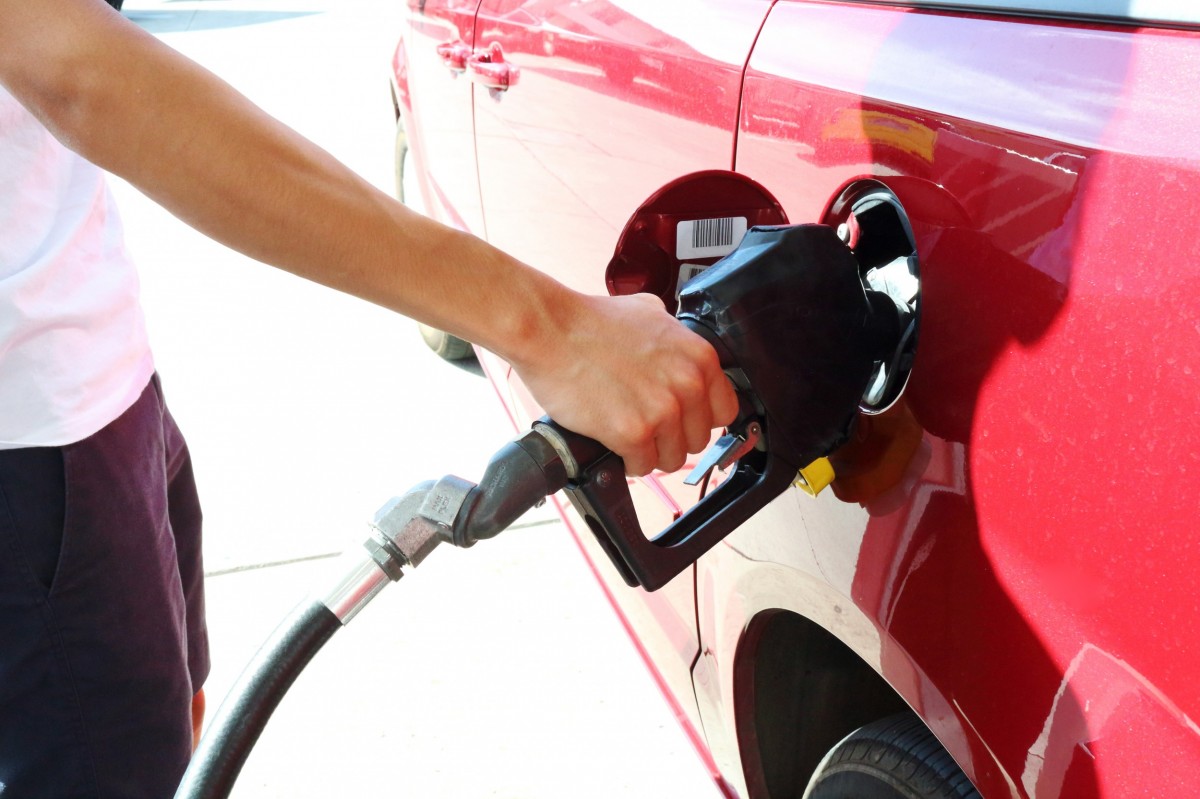 man putting fuel in car 