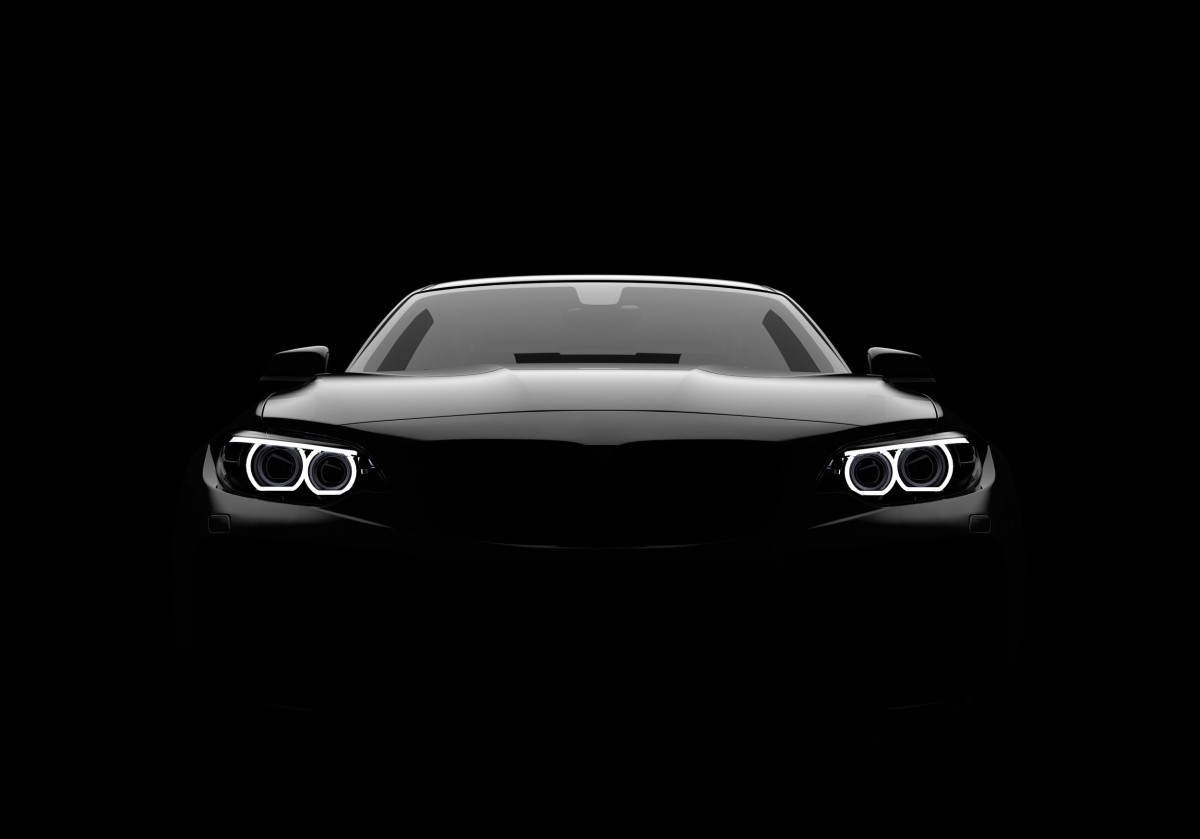 all black performance car with lights on