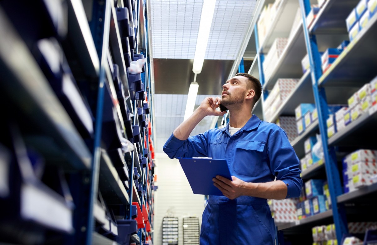 mechanic in an aisle looking at car parts